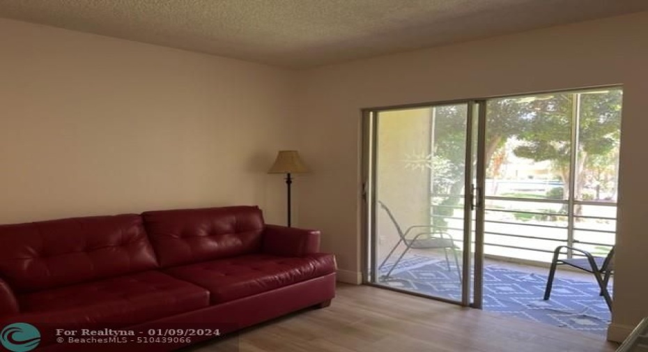 Living area w/sliders to screened balcony