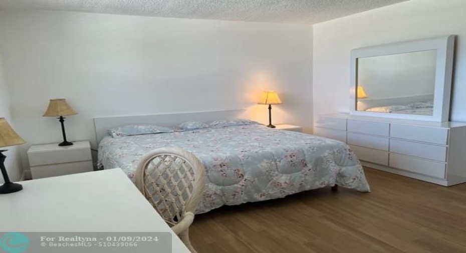 Spacious bedroom accommodates this king bed & furniture w/ease