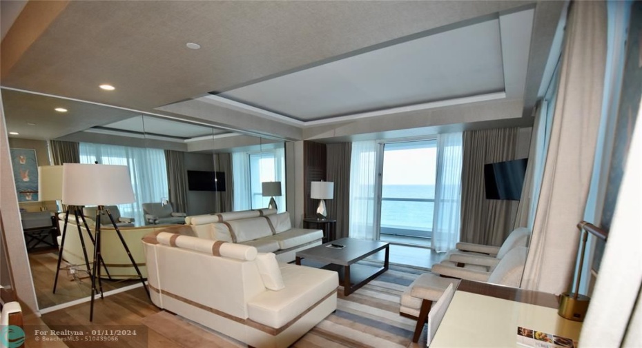 Living room w/ access to direct ocean terrace
