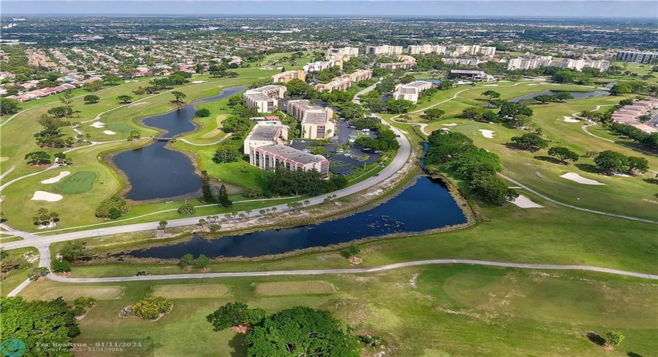 AERIAL VIEW (BUILDING IN CENTER FRONT BETWEEN LAKES) SURROUNDED BY GOLF COURSE LAND
