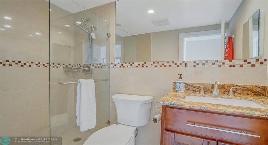 Master bath has been completely remodeled with porcelain tile walls, granite countertops, mosaic accent and designer lighting.   Glass enclosed shower.