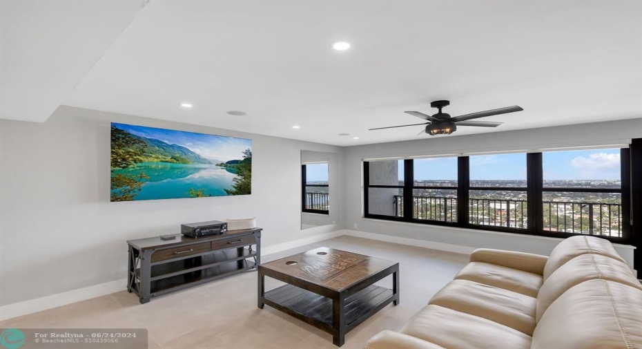 Living room has ceiling mounted Bluetooth speakers
