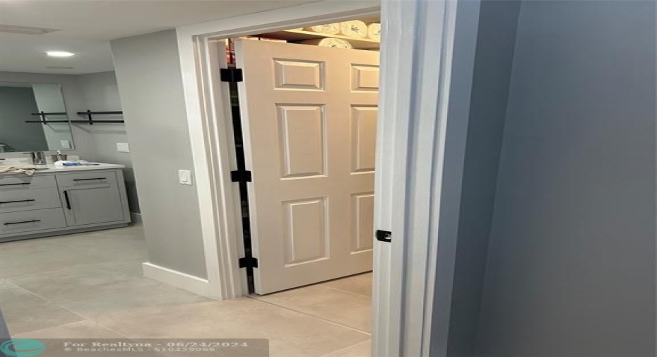 Primary bedroom walk-in closet and bathroom entry