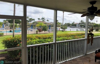 View from living area screened patio overlooking pool & waterway canal