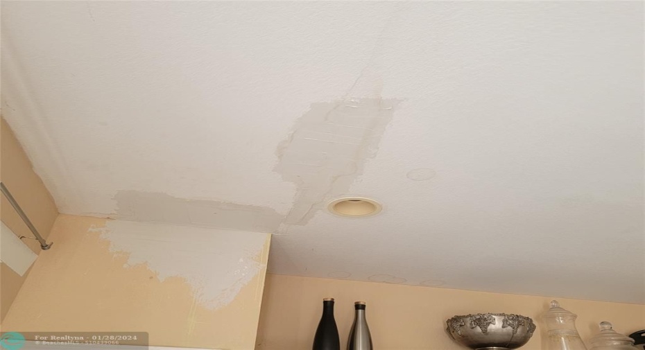 Stain in ceiling from past primary bath shower leak.