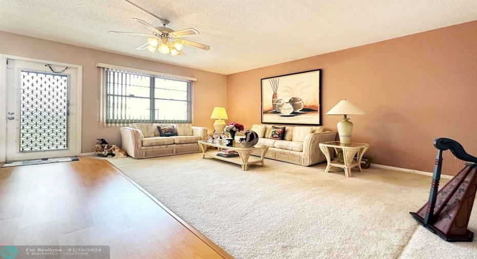 Carpeted Living Room w/Laminate Flooring Leading to Bedrooms