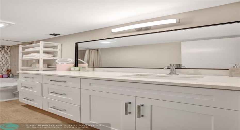 Primary Bedroom En-Suite Bathroom with new vanity, mirrors and lights,