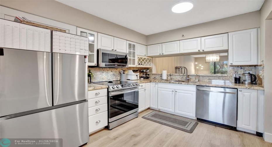 The Kitchen has new stainless-steel appliances, white cabinets with plenty of storage and a breakfast nook.