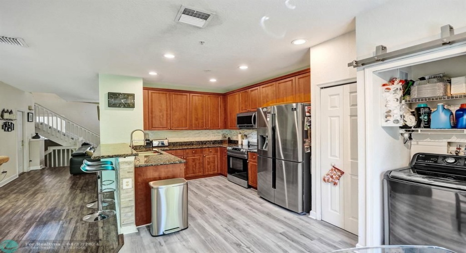 Additional storage closet to the right of the refrigerator.