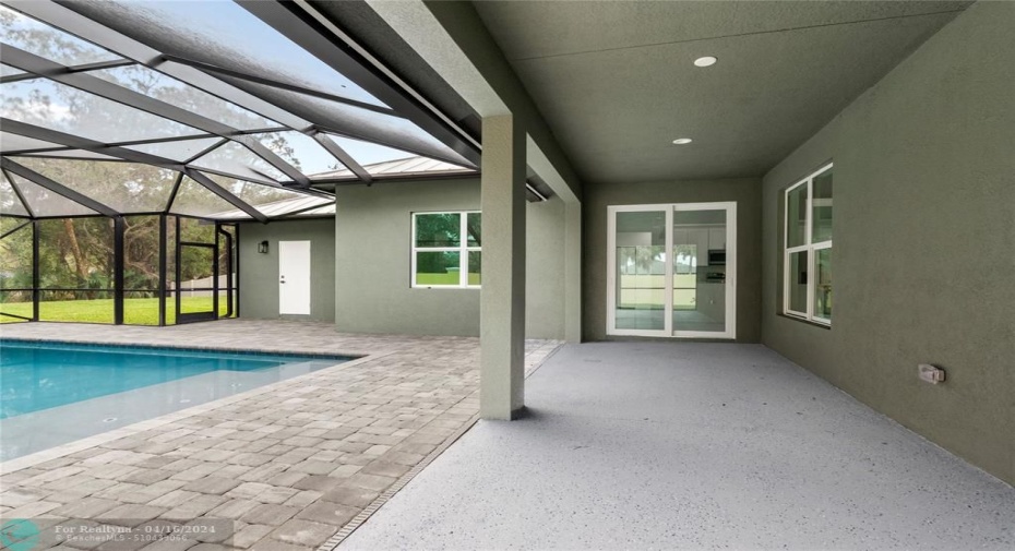 pool and covered patio.  White door to bathroom #3.