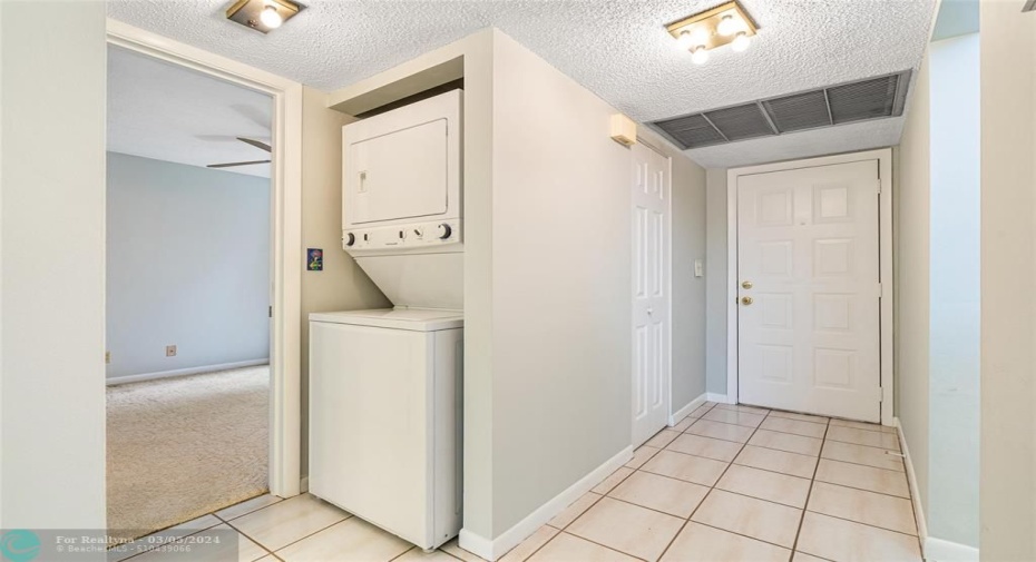 Full size washer dryer and more storage in the foyer