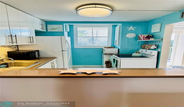 Kitchen is open to the living room- and it has a window! So bright and cheery!