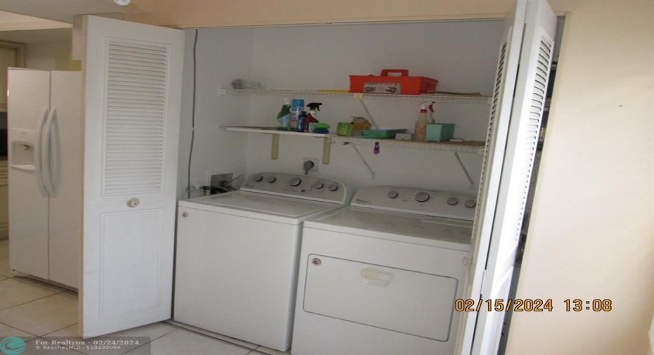 Full-size washer and dryer in kitchen pantry.
