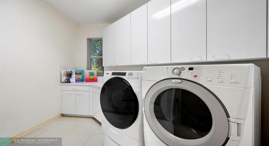 Full sized washer and dryer, cabinets and folding area, plus sink and closet!