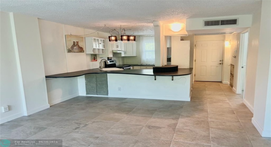 Open Kitchen with wavy, extended countertop