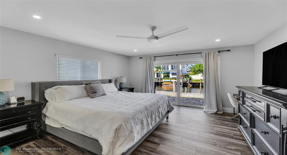 Master Bedroom is spacious and bright with impact sliders out to pool and water