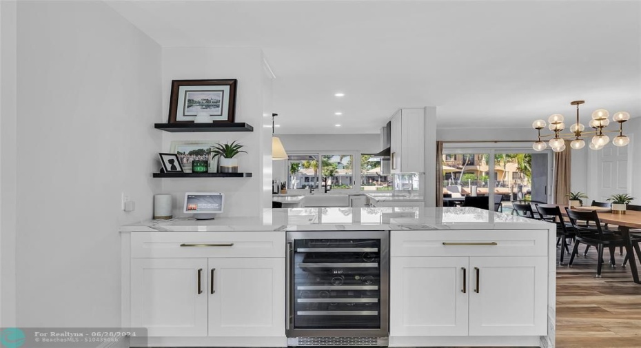 This spacious entertaining win fridge and quartz countertop is shared with the living room and kitchen