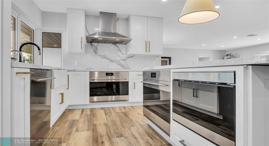 Stainless steel appliances and a Wolf double oven features in kitchen
