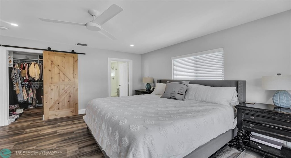 Master Bedroom offers high-hat lighting and farm door into closet