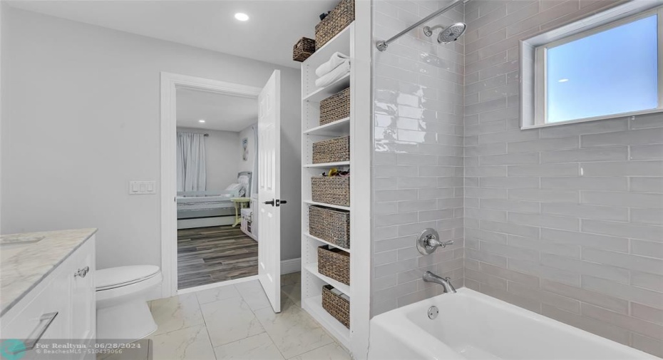 Jack and Kill bathroom offers a tub/shower combo with subway tile and storage niche