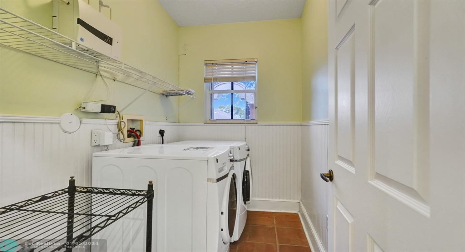 under-air laundery room featuring updated washer and dryer