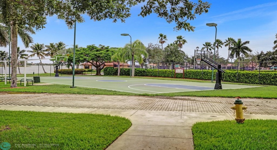 HOA common area featuring a basketball court /lighting