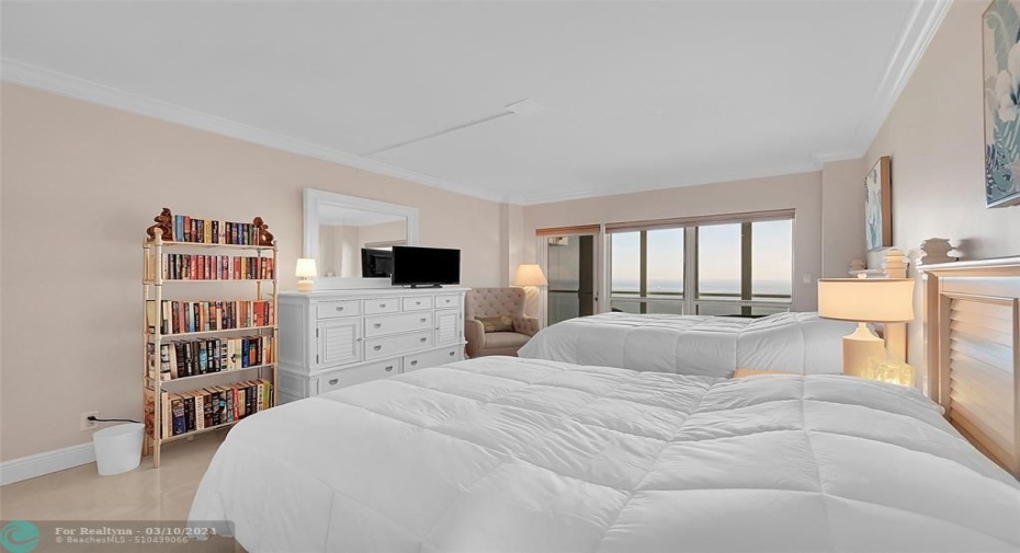2nd bedroom with floor-to-ceiling windows and direct balcony access