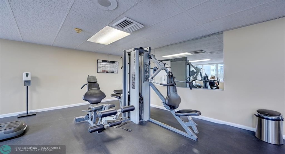 Gym with cable machine, treadmills, ellipticals, bike, weights, mats and TV's