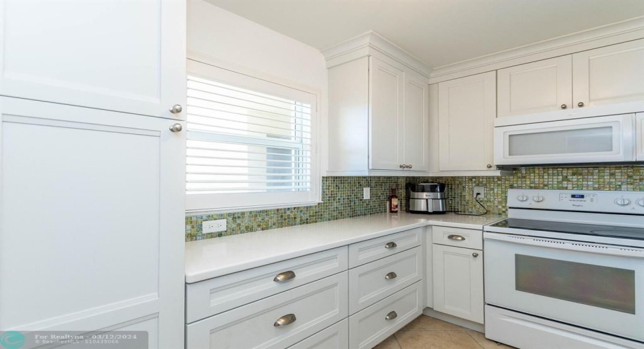 Corian counters, hand painted backsplash