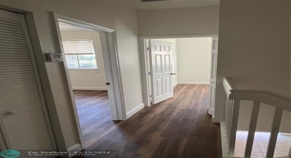 View of 2 bedrooms and hall from main bedroom door