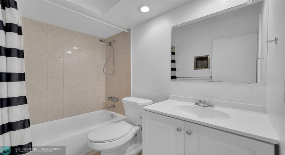 Guest bathroom with combination shower/tub