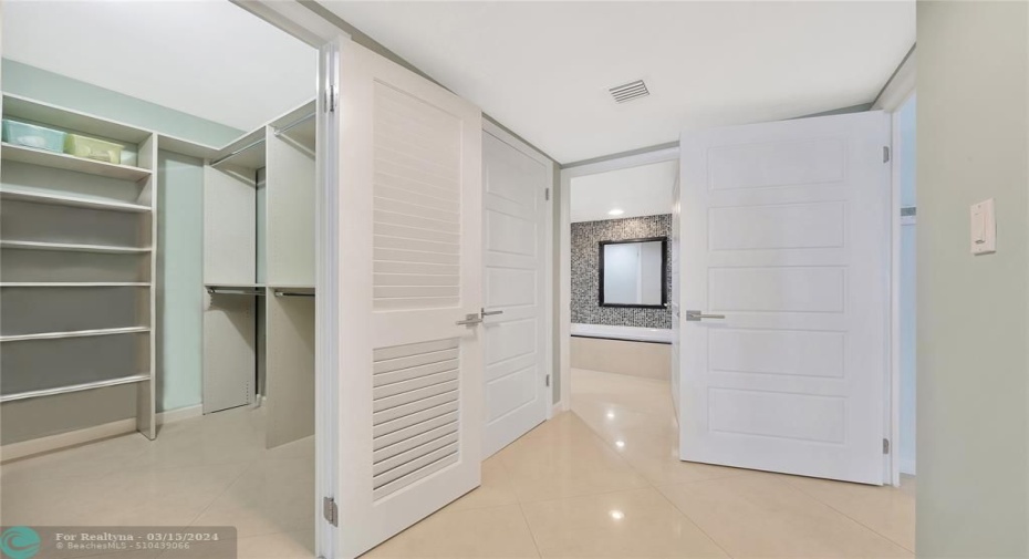 Large walk-in closet in the Master Suite with built-ins along with an en suite bathroom.