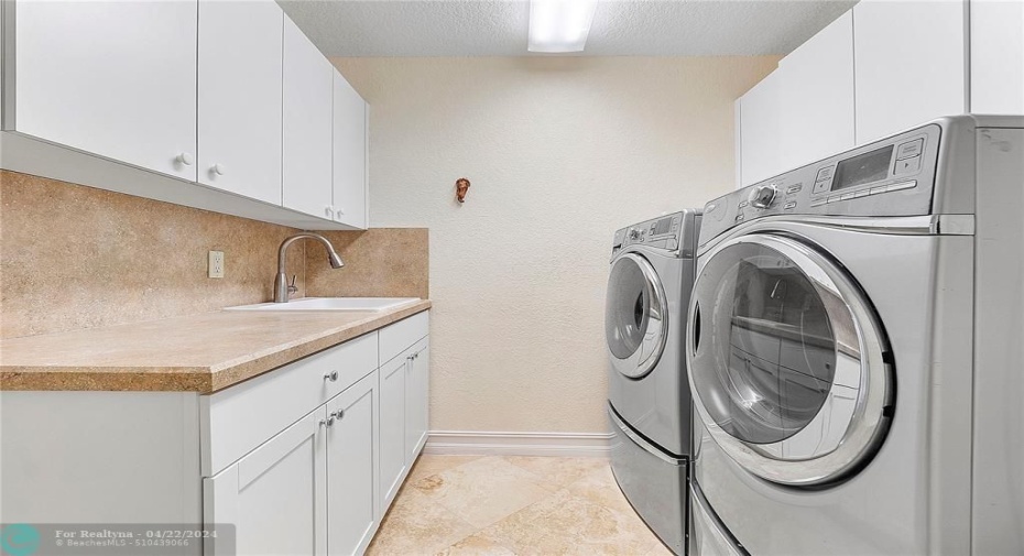 Large laundry room with utility sink.