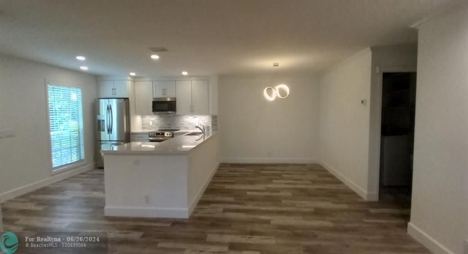 Living room view of kitchen and dining area