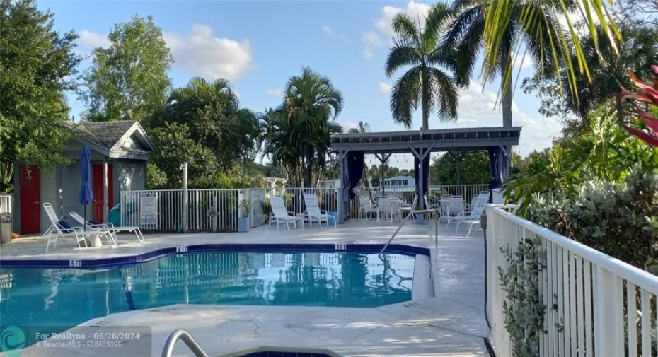 Pool area with shade structure and restrooms