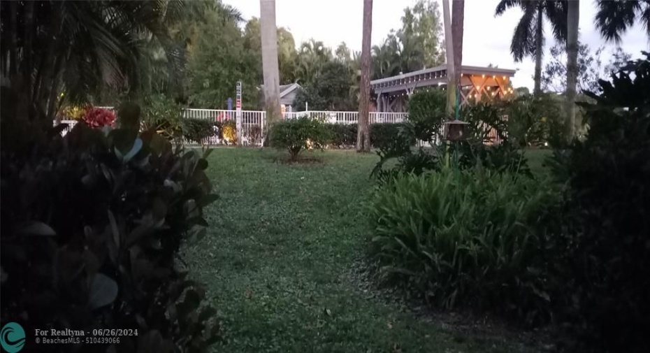 Pool pavilion lit at night with string lights