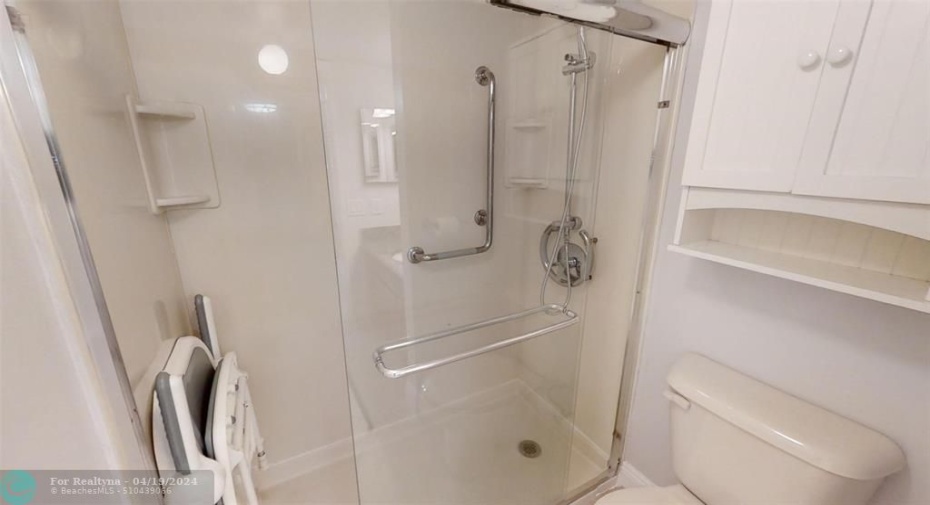 shower with installed seat and hand held shower wand