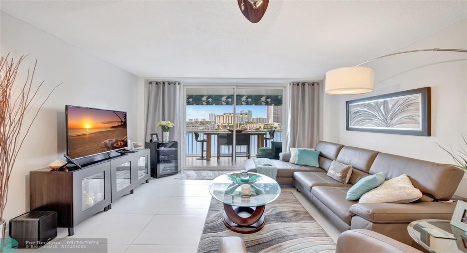 LIVING ROOM WITH WELL DESIGNED FURNITURE AND BALCONY VIEW