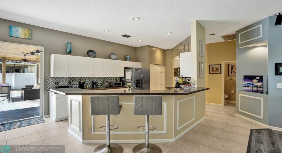 A Place to Connect and Create:  This kitchen is more than just a functional space; it's a place to connect with loved ones, create lasting memories, and enjoy the joy of cooking.  With its open layout, top-of-the-line appliances, and modern finishes, this kitchen is the heart of this beautiful home.