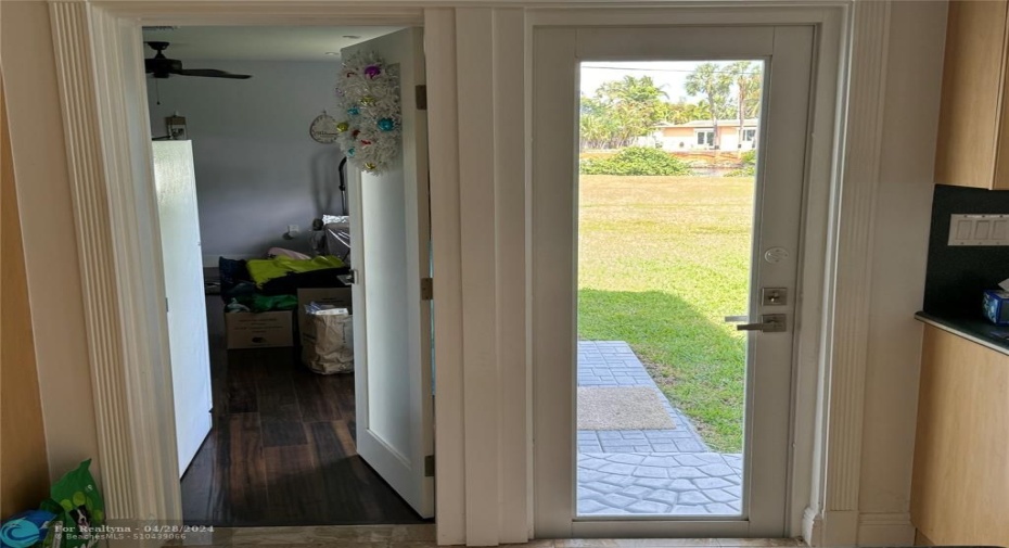 Door to right leads to back yard and OCEAN ACCESS waterway. Door to the left provides access for the 2nd 3/2 home built in 2018. Be sure to see all the blueprint plans provided here. 2nd house has own outside entrance and can be completelyl separated from the main 3/2 home.