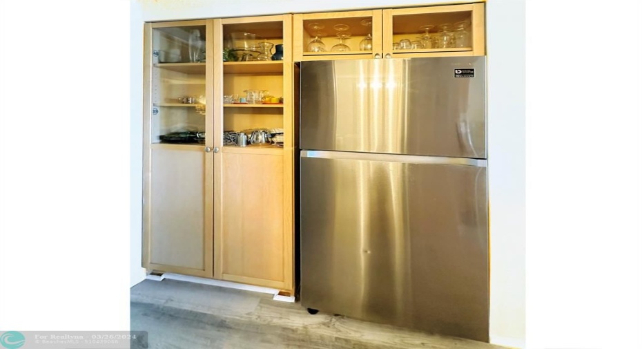 Refrigerator is Off Set from Kitchen Surrounded by Built-in Pantry.