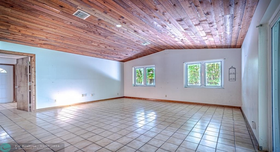 Incredible large family room with nice wood finished vaulted ceiling, has electric outlet to install ceiling fan or chandelier. Door on the left goes to 4th bedroom and second entry door. ( room was used as office space)