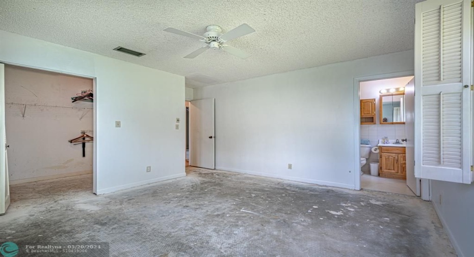 Primary suite with ensuite bathroom and walk-in-closet. Carpet has been removed, ready to install your flooring.