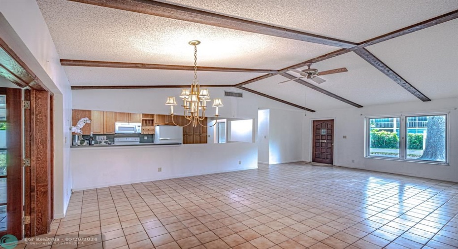 Ample space to transform this space into a complete open Kitchen, dining and living room. Love the vaulted ceilings!