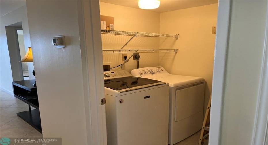 Laundry room with Full size washer dryer with storage