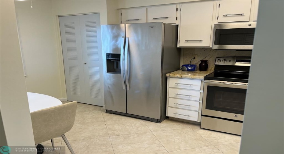 Updated kitchen with stainless steel appliances and granite countertops