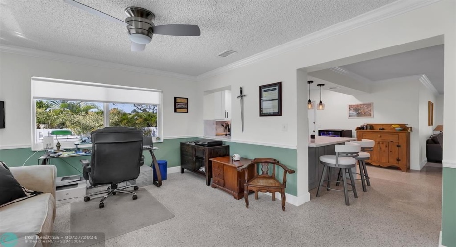 This large den area off the kitchen can be used as an office, studio, or family room