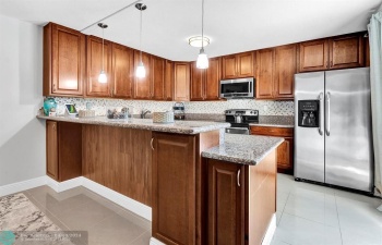 Renovated with granite, lots of cabinets & snack counter for your convenience
