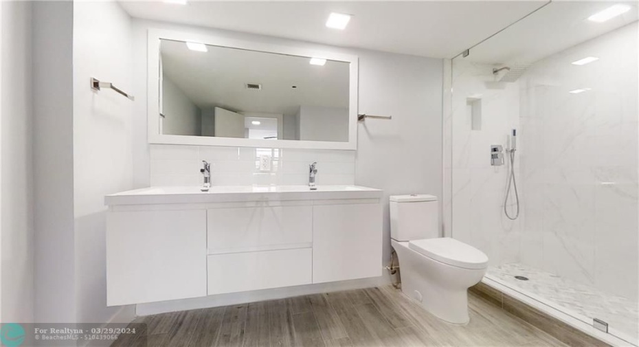 Main bathroom with double vanity and shower