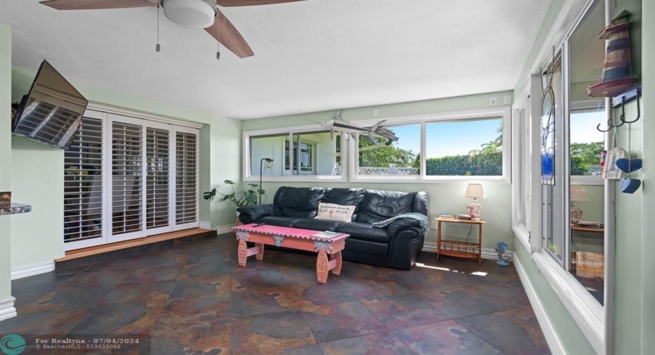 Stylish Plantation shutters (throughout the home) offer privacy from living room to Florida room